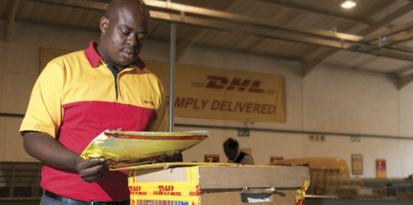 DHL worker sorting packages