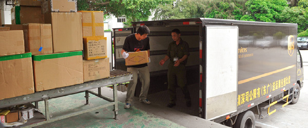 UPS truck receiving packages from loading dock in China