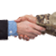 Handshake between people dressed in business suit and camo