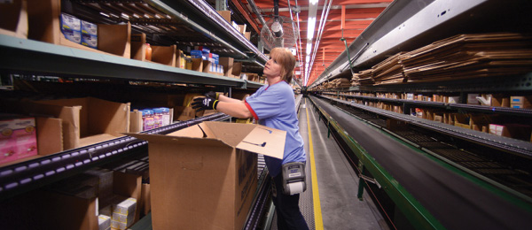 A Walmart associate stocks inventory on warehouse shelves